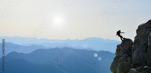 Fotografiet crazy climber climbing against the sunset