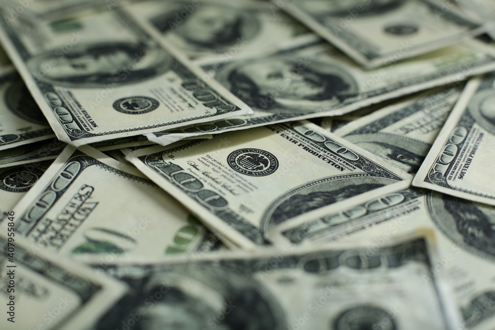 A pile of one hundred US banknotes with president portraits. Cash of hundred dollar bills, dollar background image with high resolution A pile of one hundred US banknotes with president portraits. Cash of hundred dollar bills, dollar background image with high resolution