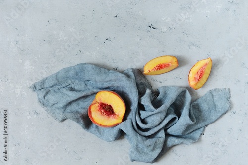 Ripe peach on a gray (blue) background. Juicy summer fruit, copy space.