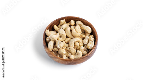 Cashews in wooden bowl isolated on a white background.