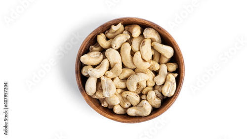 Cashews in wooden bowl isolated on a white background.