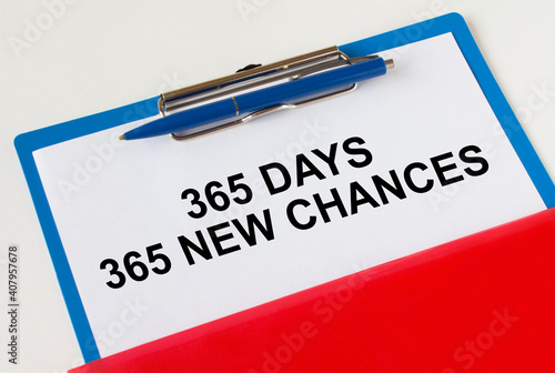 Clipboard with text 365 days 365 New Chances blue pen and red folder