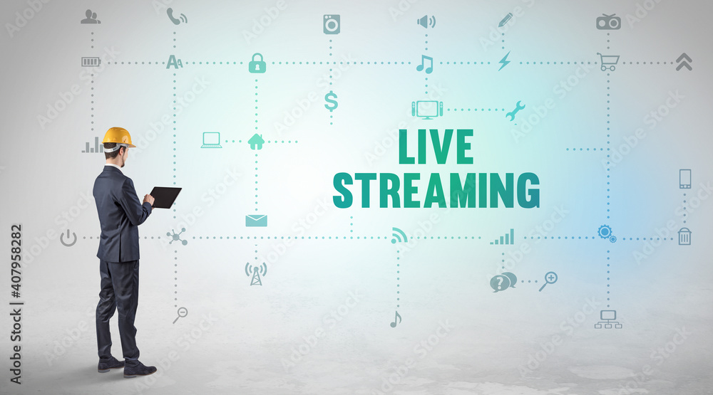 Engineer working on a new social media platform with LIVE STREAMING inscription concept Engineer working on a new social media platform with LIVE STREAMING inscription concept