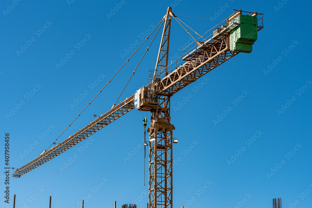 Industrial landscape with silhouettes of cranes on the sunset background