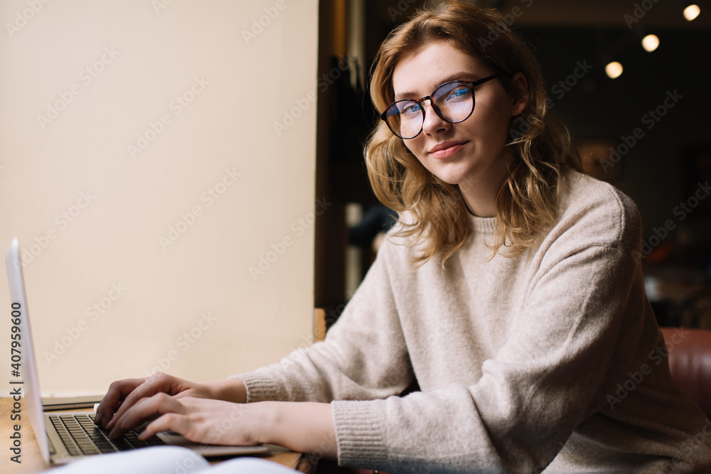 Young female freelancer typing on laptop Young female freelancer typing on laptop