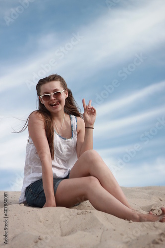 girl on the beach against the blue sky