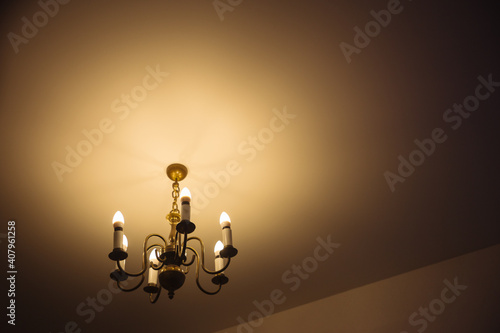 Old lamp with LED bulbs on white ceiling