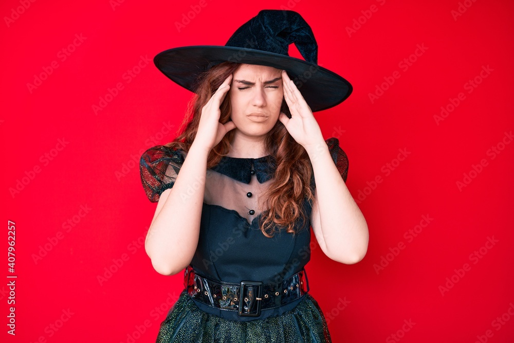 Young beautiful woman wearing witch halloween costume with hand on head, headache because stress. suffering migraine. Young beautiful woman wearing witch halloween costume with hand on head, headache because stress. suffering migraine.