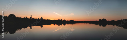 Fototapeta Naklejka Na Ścianę i Meble -  Sunset over a forest lake