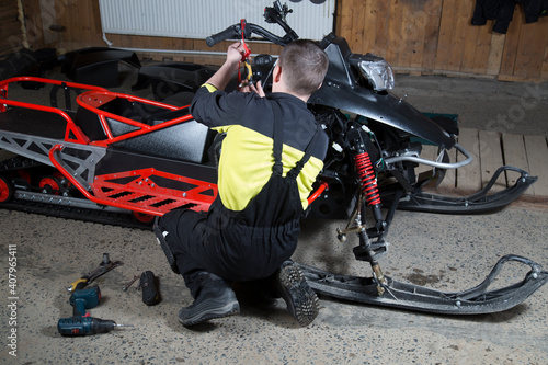 Repair and maintenance of snowmobiles. Maintenance of motor vehicles.