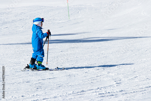 Gusar - Azerbaijan: January 2019. Child skiing in mountains. Ski race for young children. Winter sport. Little skier racing on snow photo