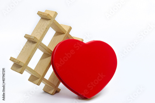 Fotografia Red heart with a wooden decorative grid on a white background.
