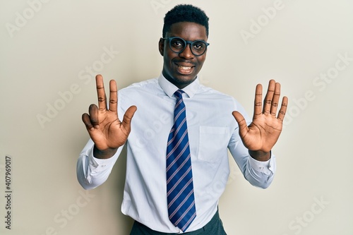 Handsome black man wearing glasses business shirt and tie showing and pointing up with fingers number eight while smiling confident and happy.