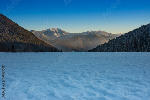 Snow covered ground and hills.Winter landscape during the evening.