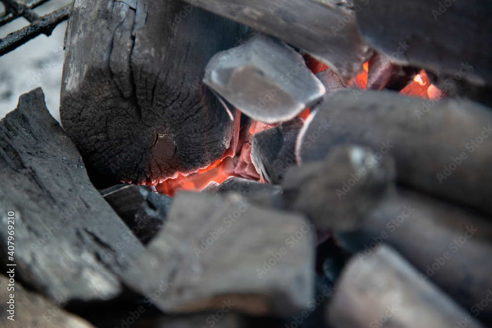 Close up of brightly burning wooden logs with yellow hot flames of fire.. Close up of brightly burning wooden logs with yellow hot flames of fire..