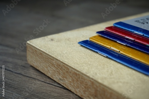 school multi-colored notebooks. wooden surface. study at home. self-isolation.