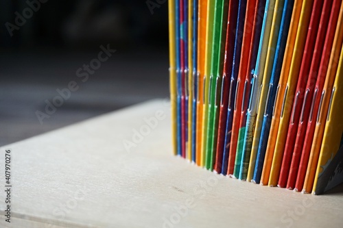 multicolored school brochure on wooden surface