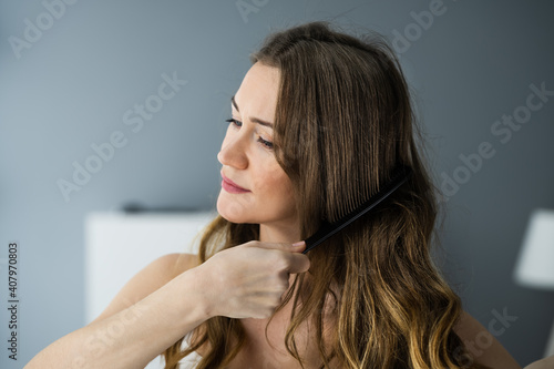Woman Using Comb Combing Long Hair