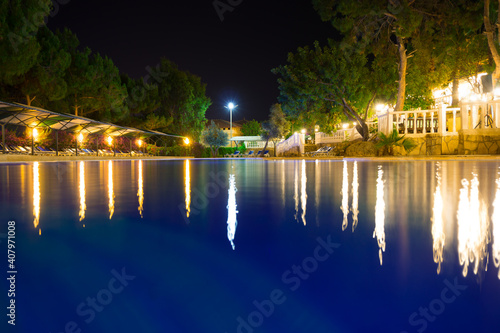 Territory and swimming pool of the hotel Larissa Greene Hill Beach at night in Alanya, Turkey photo