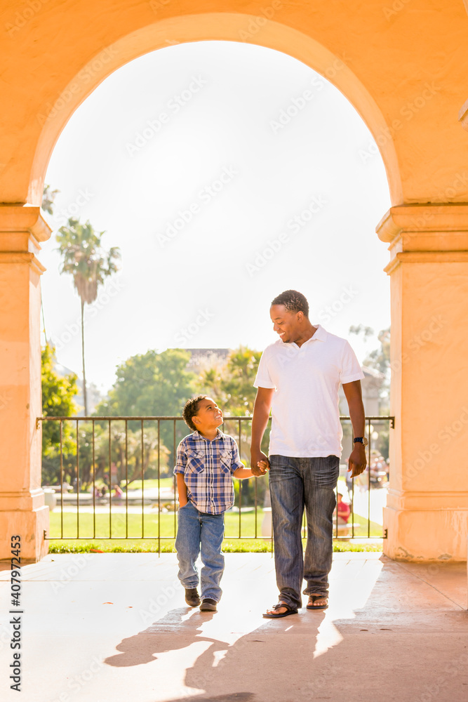 Happy African American Father and Mixed Race Son Walking At The Park