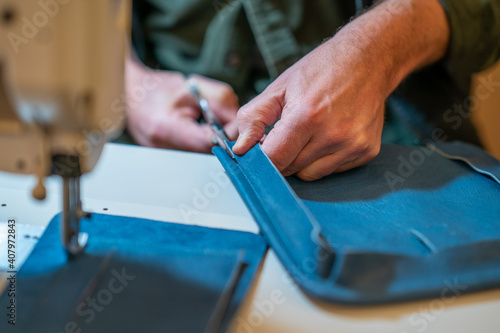 Hands cutting leather product