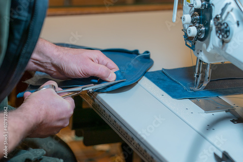Hands making leather product