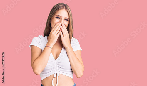 фотографія Young beautiful blonde woman wearing casual white tshirt laughing and embarrasse
