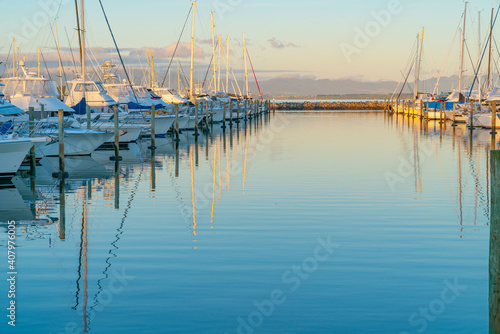 Tauranga Marina boats and piers reflected in calm water at sunrise © Brian Scantlebury
