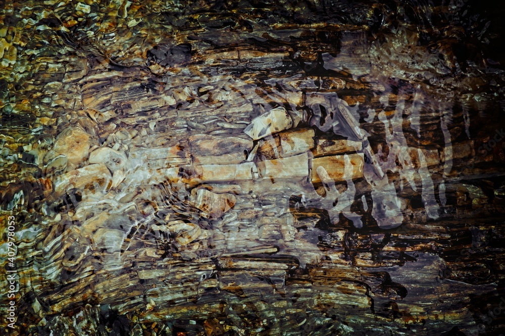 Top view of the eroded stone bed of a creek consisting of brown shale