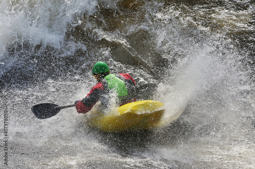 kayaking in the rapids in a river