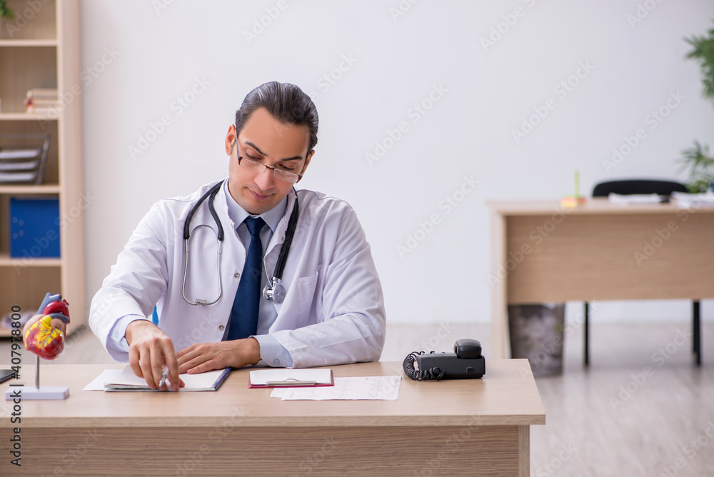 Young male doctor lecturer cardiologist working in the clinic Young male doctor lecturer cardiologist working in the clinic