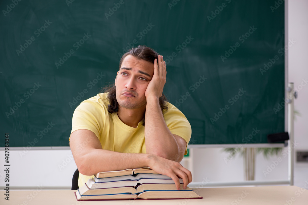 Young male student preparing for exams in the classroom Young male student preparing for exams in the classroom