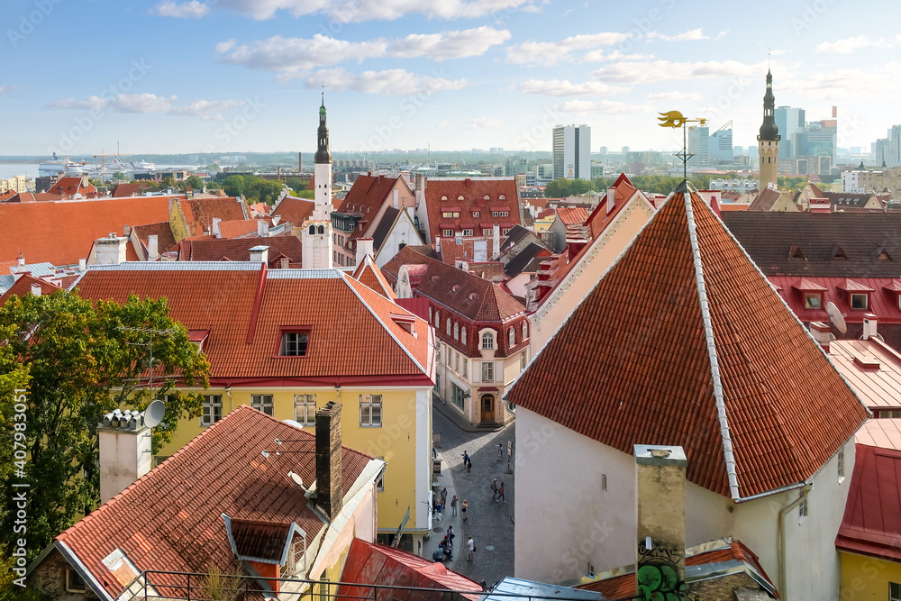 View of the Old Town of the Baltic city of Tallinn Estonia from the lookout point on Toompea Hill, with the cruise port ships visible in the distance.