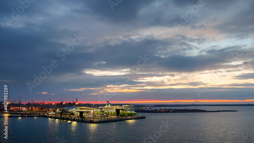 Sunrise on an early morning on the Baltic coast of Helsinki Finland with the cruise ship port in view from the sea.