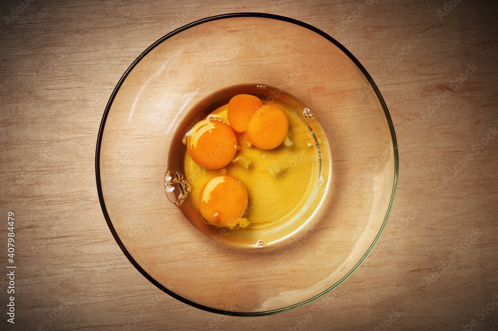 Close-up of raw egg yolks in a glass plate Close-up of raw egg yolks in a glass plate
