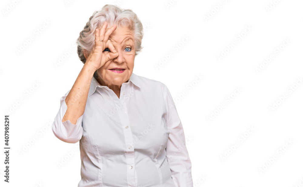 Senior grey-haired woman wearing casual clothes doing ok gesture with hand smiling, eye looking through fingers with happy face. Senior grey-haired woman wearing casual clothes doing ok gesture with hand smiling, eye looking through fingers with happy face.