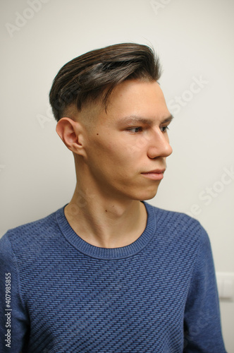 Short haircut on a young man with dark hair