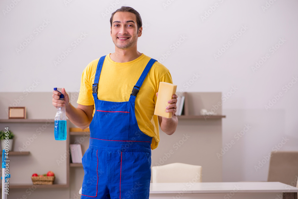 Young male contractor cleaning the house Young male contractor cleaning the house