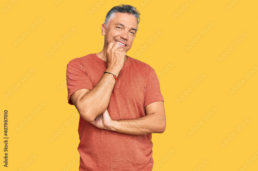 Handsome middle age man wearing casual clothes looking confident at the camera with smile with crossed arms and hand raised on chin. thinking positive. Handsome middle age man wearing casual clothes looking confident at the camera with smile with crossed arms and hand raised on chin. thinking positive.