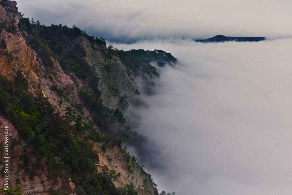 Panoramic view of the clouds in the mountains at sunrise.