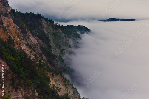 Fototapeta Naklejka Na Ścianę i Meble -  Panoramic view of the clouds in the mountains at sunrise.