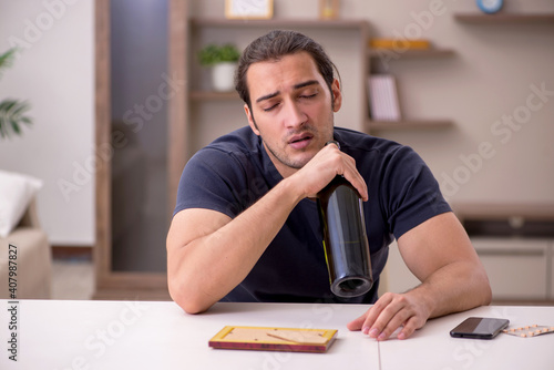 Young sick male alcoholic suffering at home