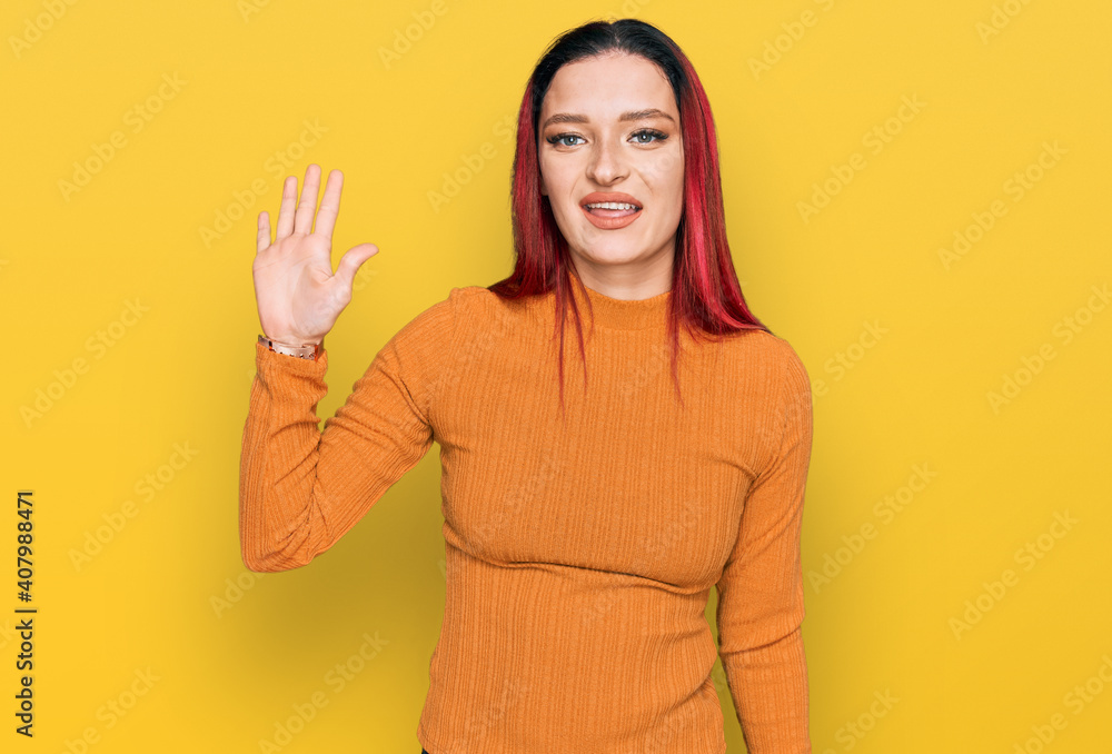 Young caucasian woman wearing casual clothes showing and pointing up with fingers number five while smiling confident and happy. Young caucasian woman wearing casual clothes showing and pointing up with fingers number five while smiling confident and happy.