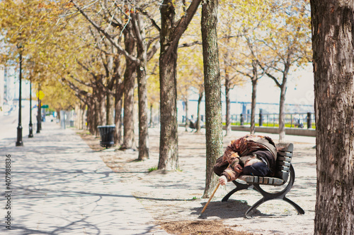elderly person lying on a park bench in old montreal during the Covid_19