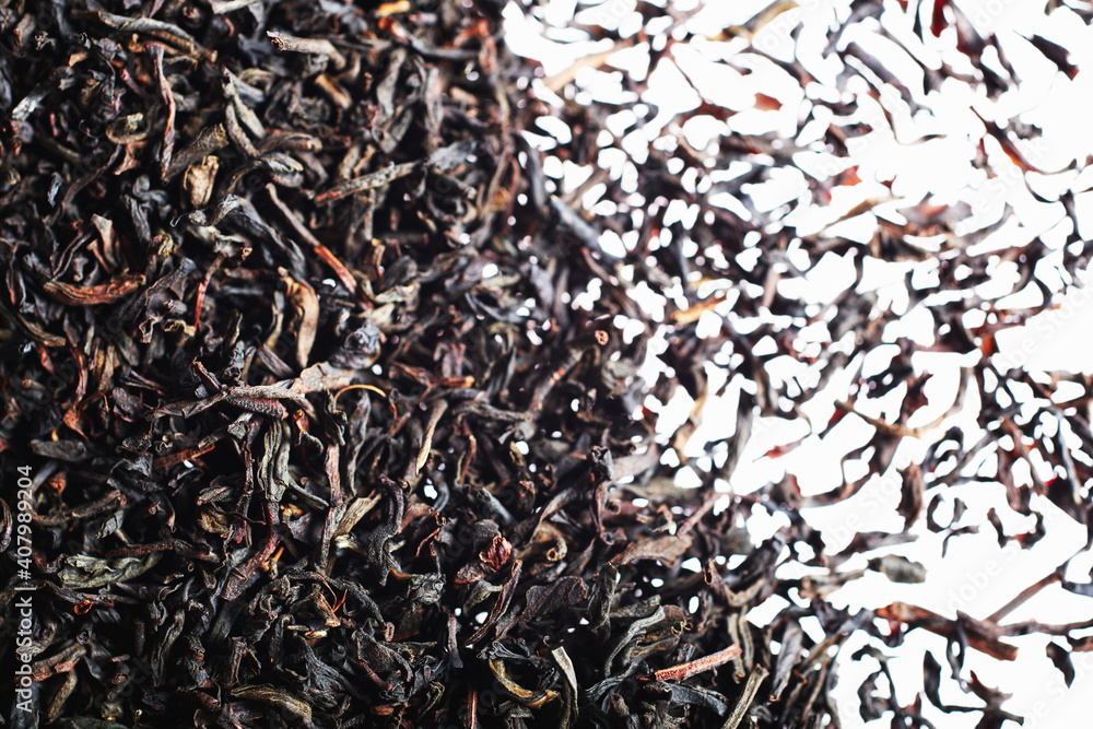 Closeup of dried black tea leaves on white background Closeup of dried black tea leaves on white background