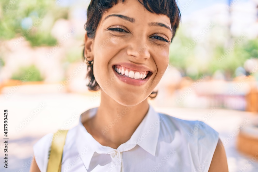 Young woman with short hair smiling happy outdoors Young woman with short hair smiling happy outdoors