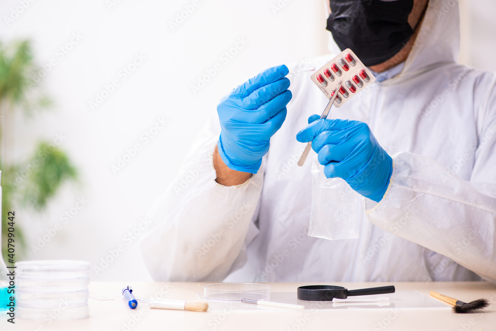 Male expert criminologist working in the lab for evidence Male expert criminologist working in the lab for evidence