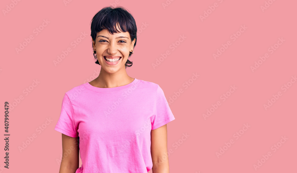 Young brunette woman with short hair wearing casual clothes with a happy and cool smile on face. lucky person. Young brunette woman with short hair wearing casual clothes with a happy and cool smile on face. lucky person.