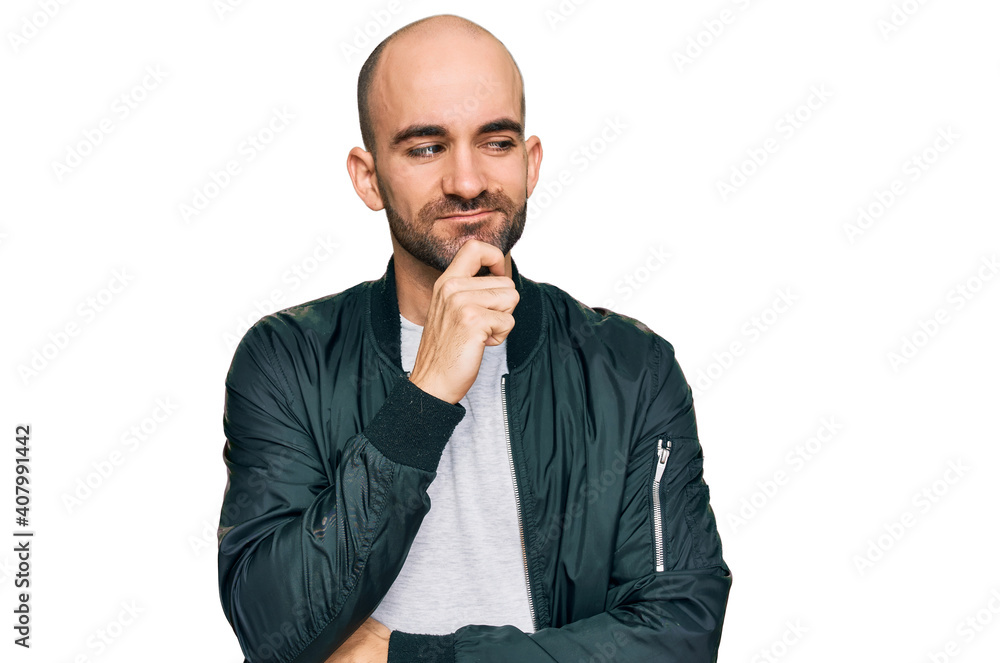 Young hispanic man wearing casual clothes with hand on chin thinking about question, pensive expression. smiling with thoughtful face. doubt concept. Young hispanic man wearing casual clothes with hand on chin thinking about question, pensive expression. smiling with thoughtful face. doubt concept.