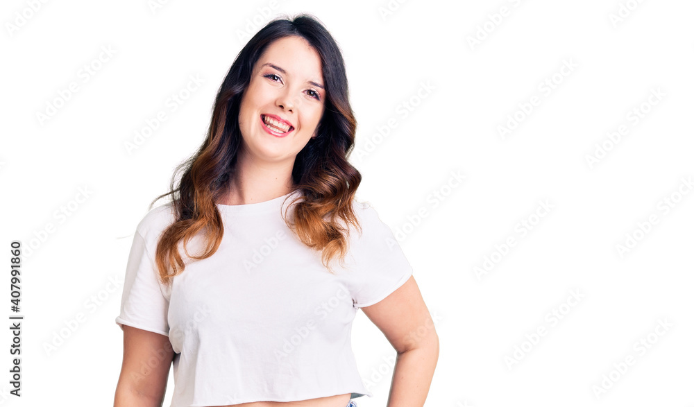Beautiful young brunette woman wearing casual clothes looking positive and happy standing and smiling with a confident smile showing teeth